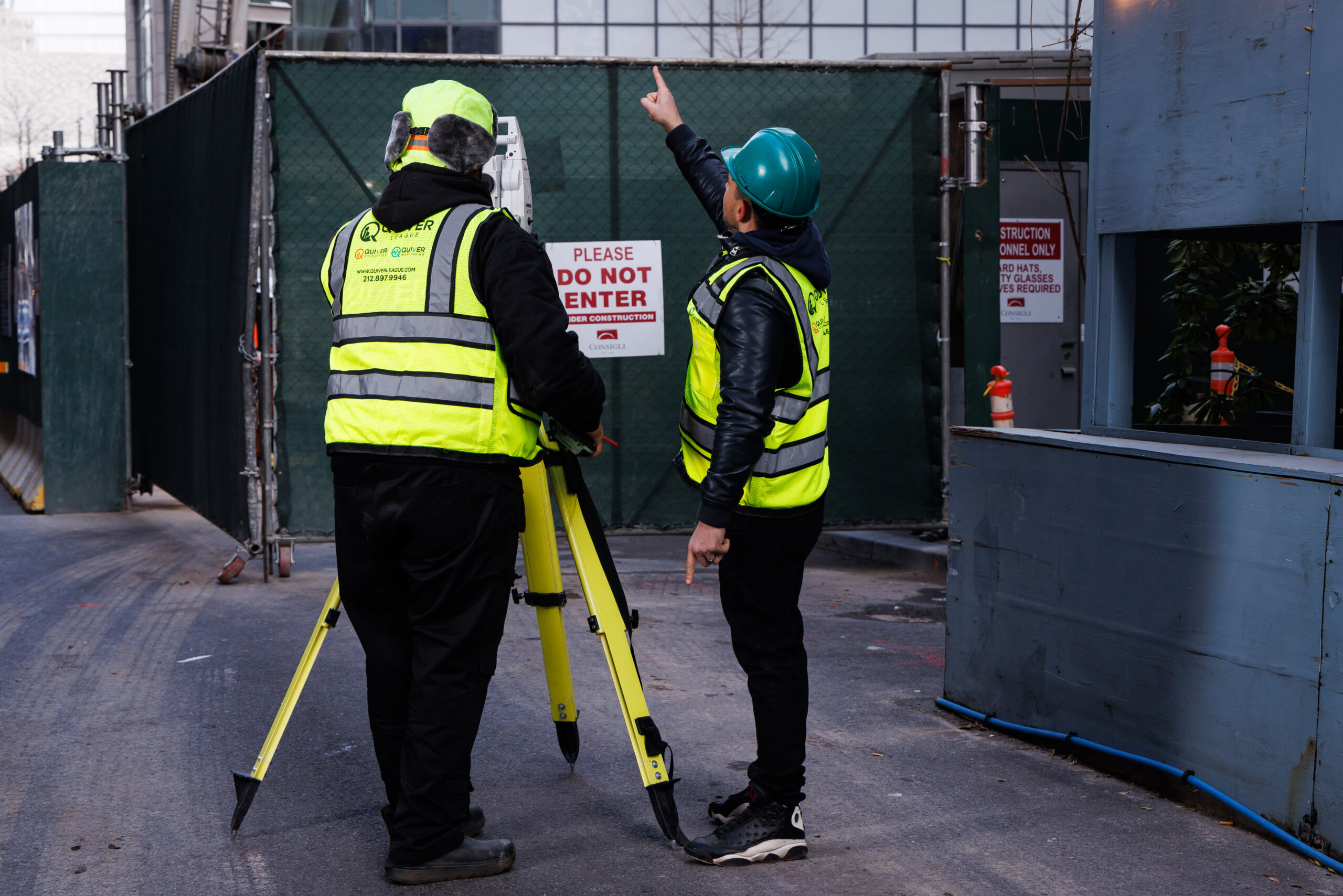 Construction workers surveying at a job site.