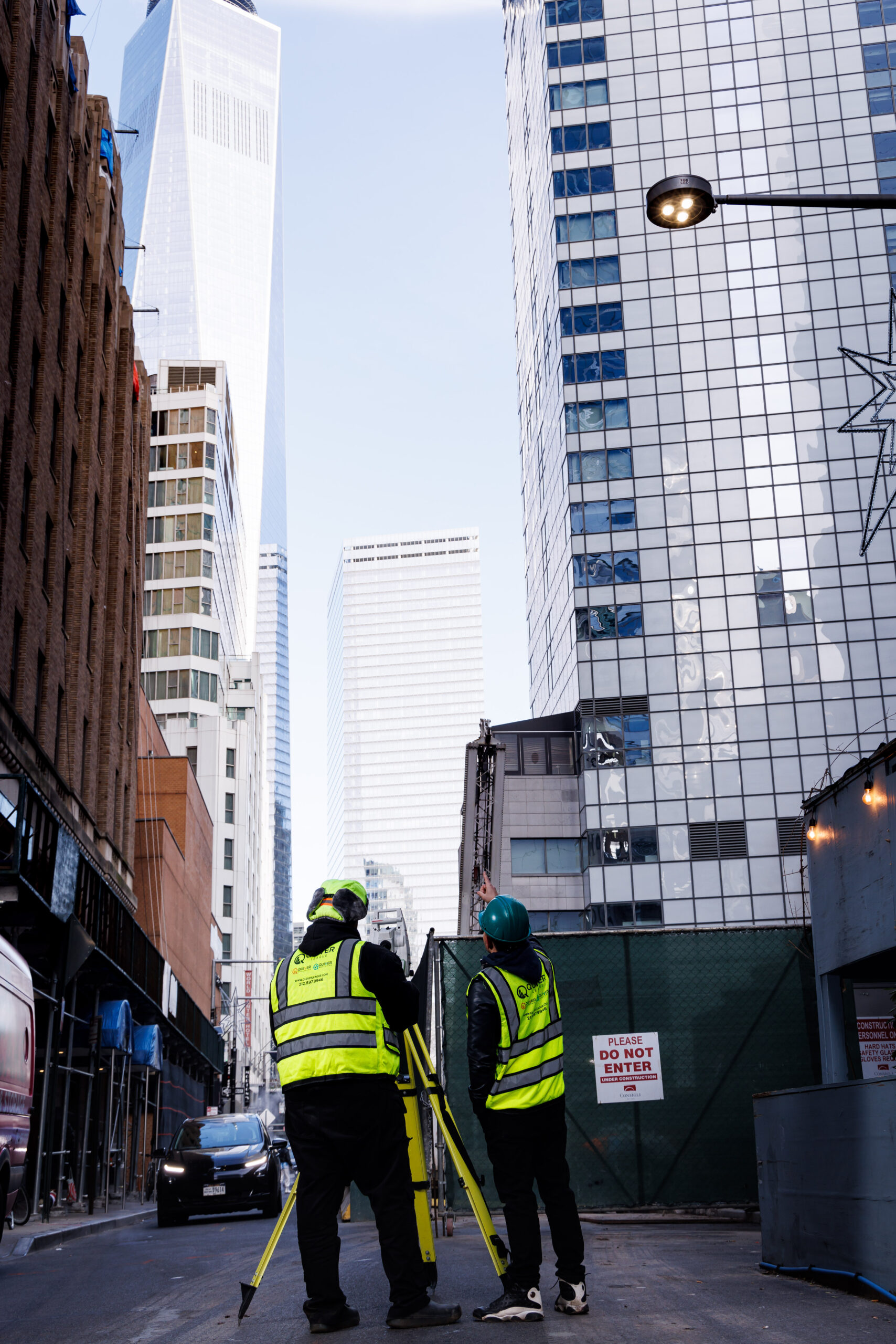 Surveyors working amidst urban skyscrapers.